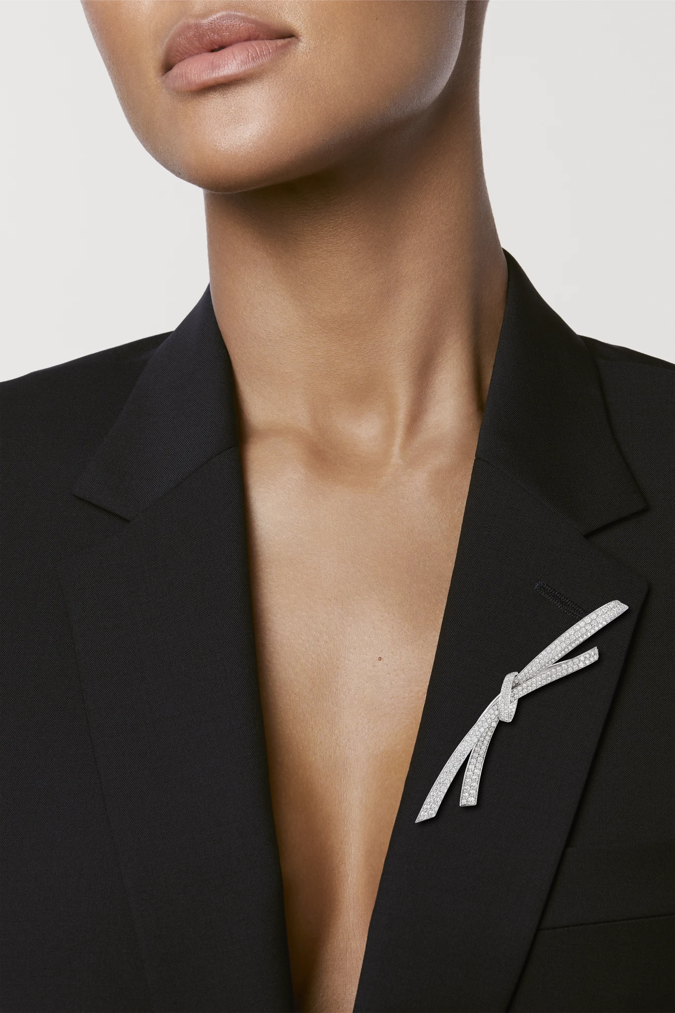 Diamond Ribbon Brooch worn on a black jacket